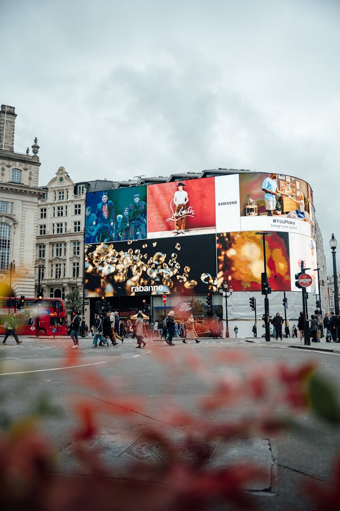 Piccadilly Circus in London bustling with people and colorful billboards.